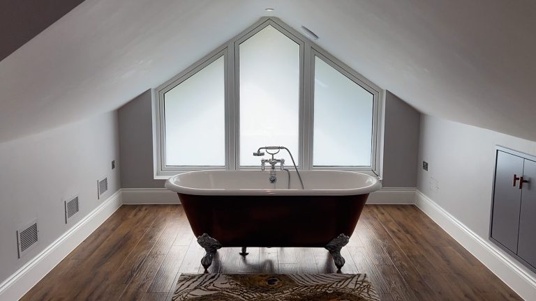 Roll top bath at large double glazed window with switchable film for home improvement