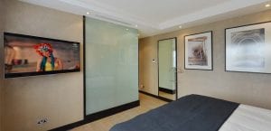 Smart glass shower cubicle in a luxury bedroom
