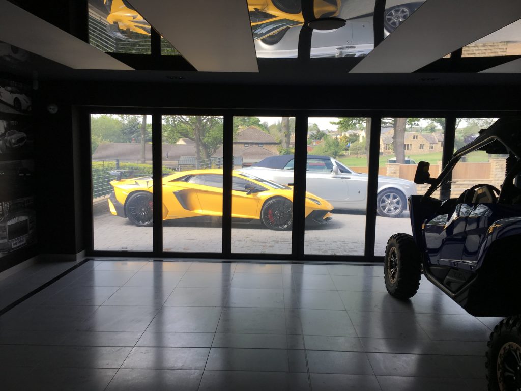 switchable smart glass garage with Lamborghini and Rolls Royce